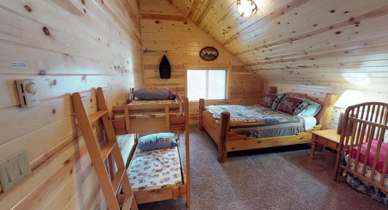 Bedroom #4 located upstairs with a Queen bed and 3 toddler beds.