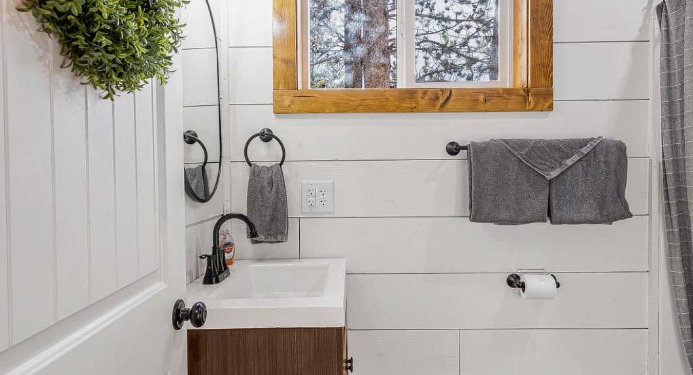 Full size bathroom with hot water on demand and a deep bathtub for soaking.