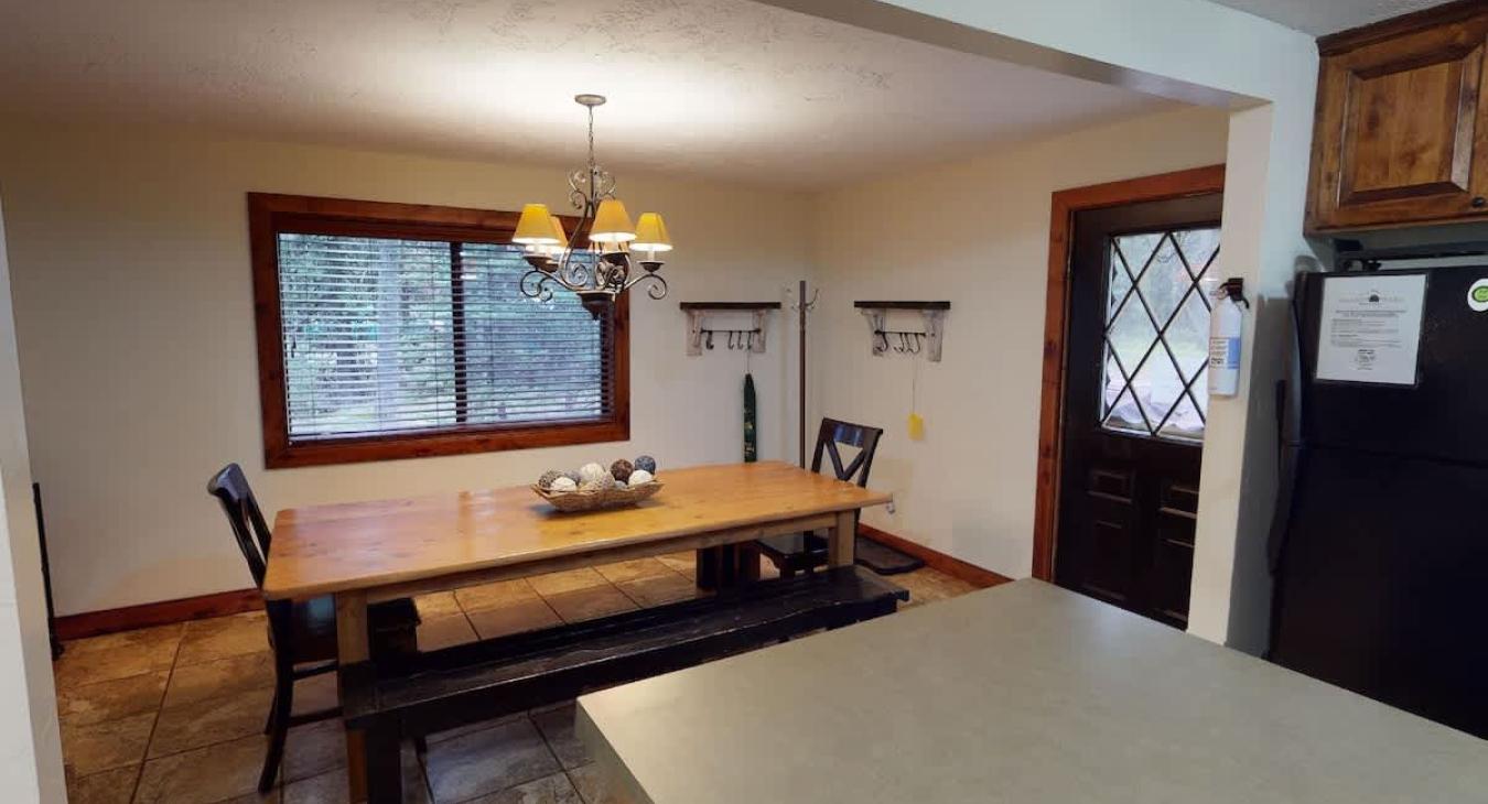 A large window is placed in the dining area to bring in natural light.