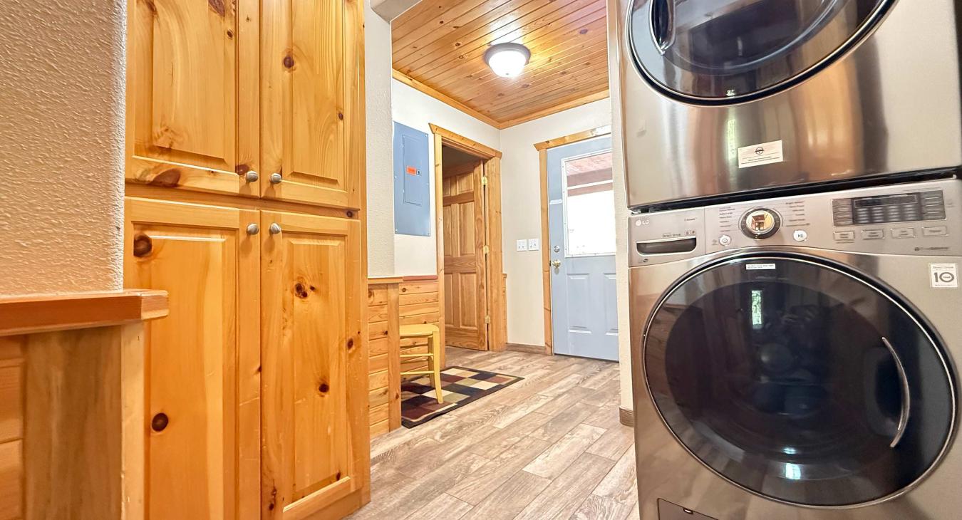 Stacked washer and dryer with laundry soap provided.
