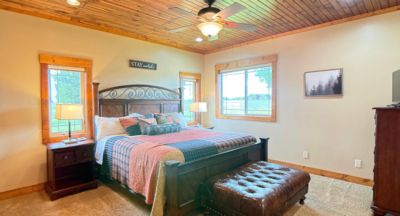 The master bedroom is located on the main floor with a King bed and large window to enjoy the beautiful surroundings.