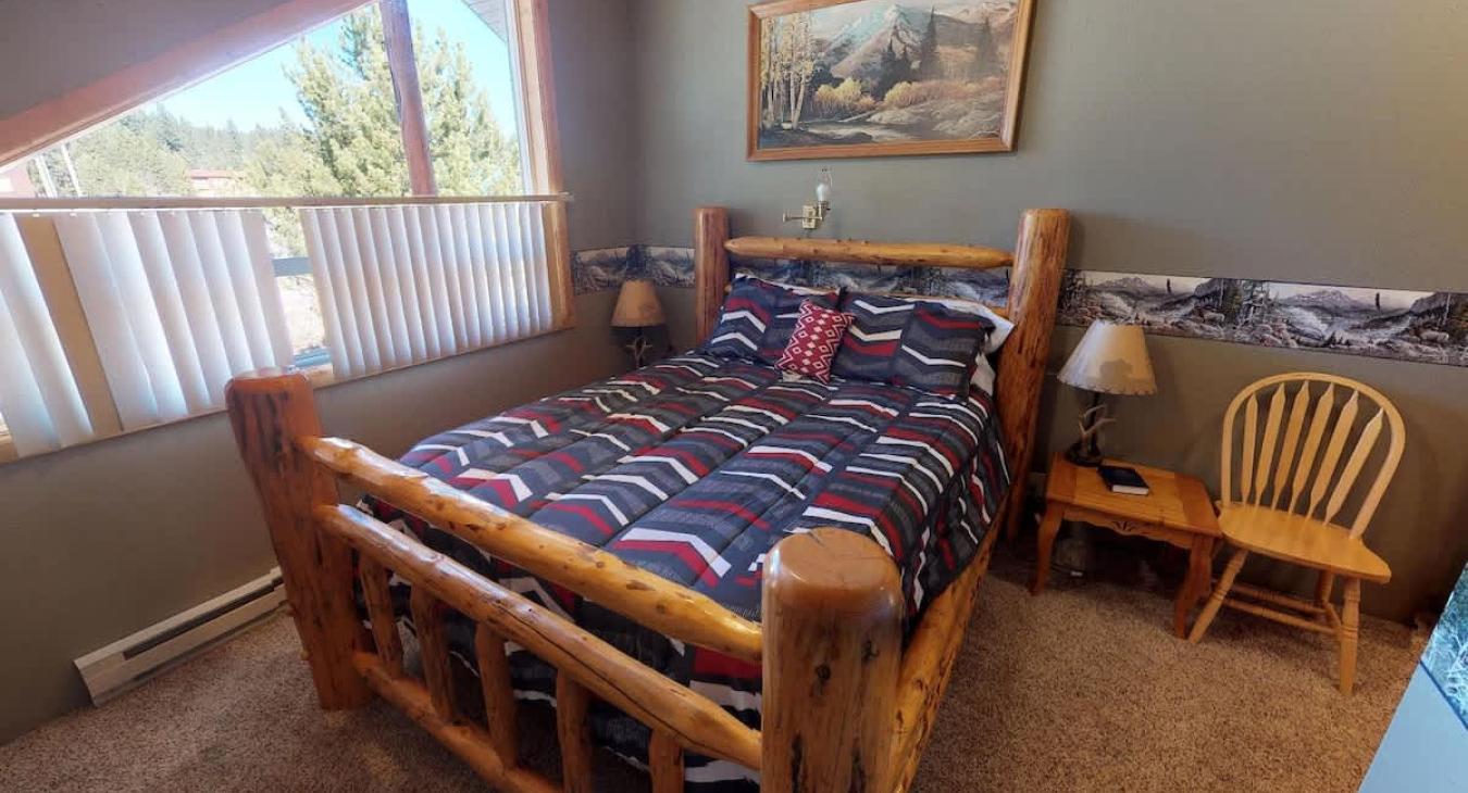 Bedroom #2 located upstairs with a Queen size bed.