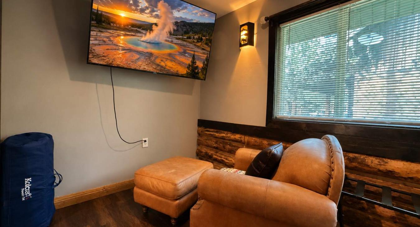 Kick back in the plush leather armchair and ottoman to enjoy movie night on the large wall-mounted Smart TV, complete with a private, cozy viewing angle.