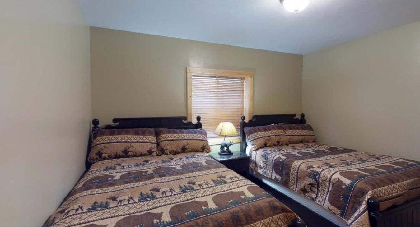 Bedroom #4 located in basement with 2 Queen size beds.