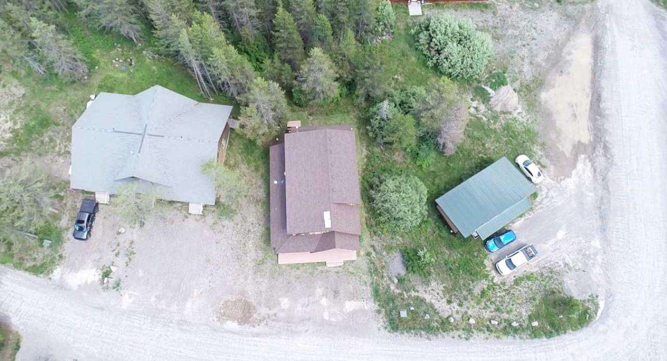 This full overhead view highlights the property's layout, offering a private lot with ample parking space for multiple vehicles or trailers.