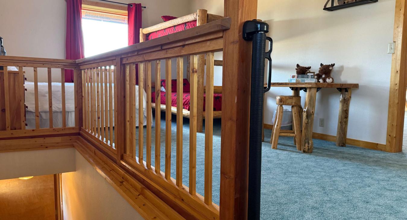 Open bedroom upstairs with child gate.