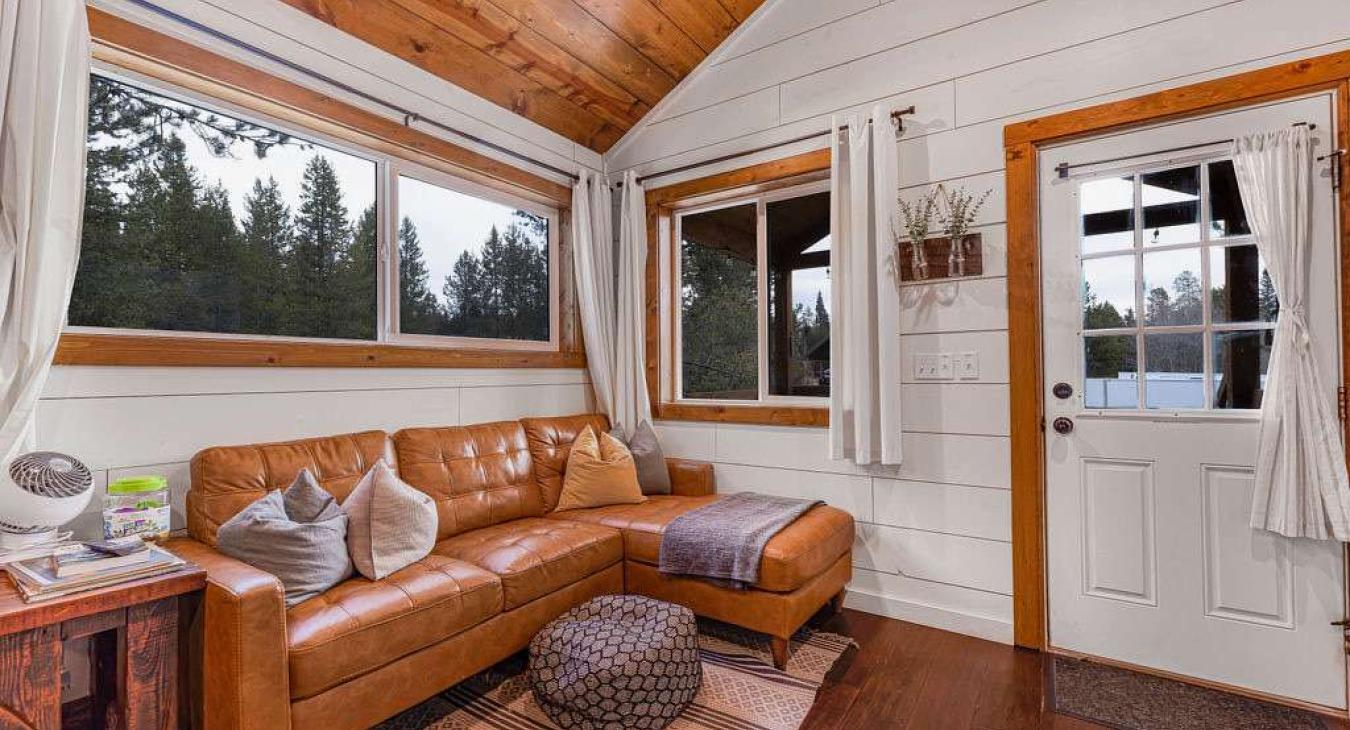 The living room with seating and tv for entertainment.