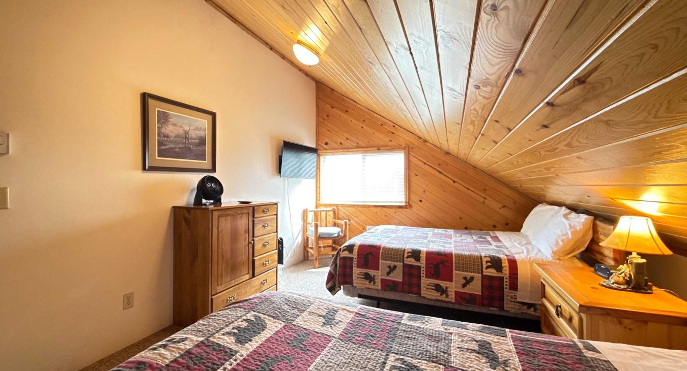 Bedroom 1 has 2 queen beds and a smart tv