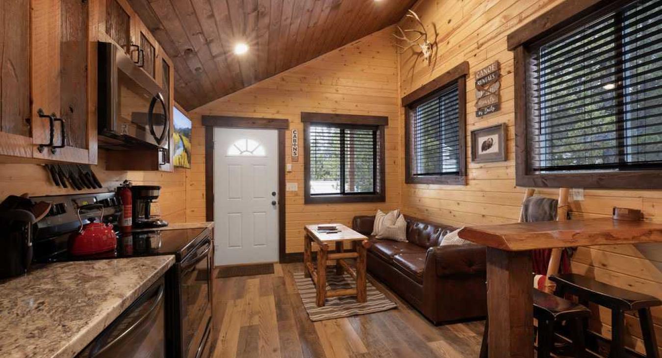 The living room with seating and tv for entertainment.