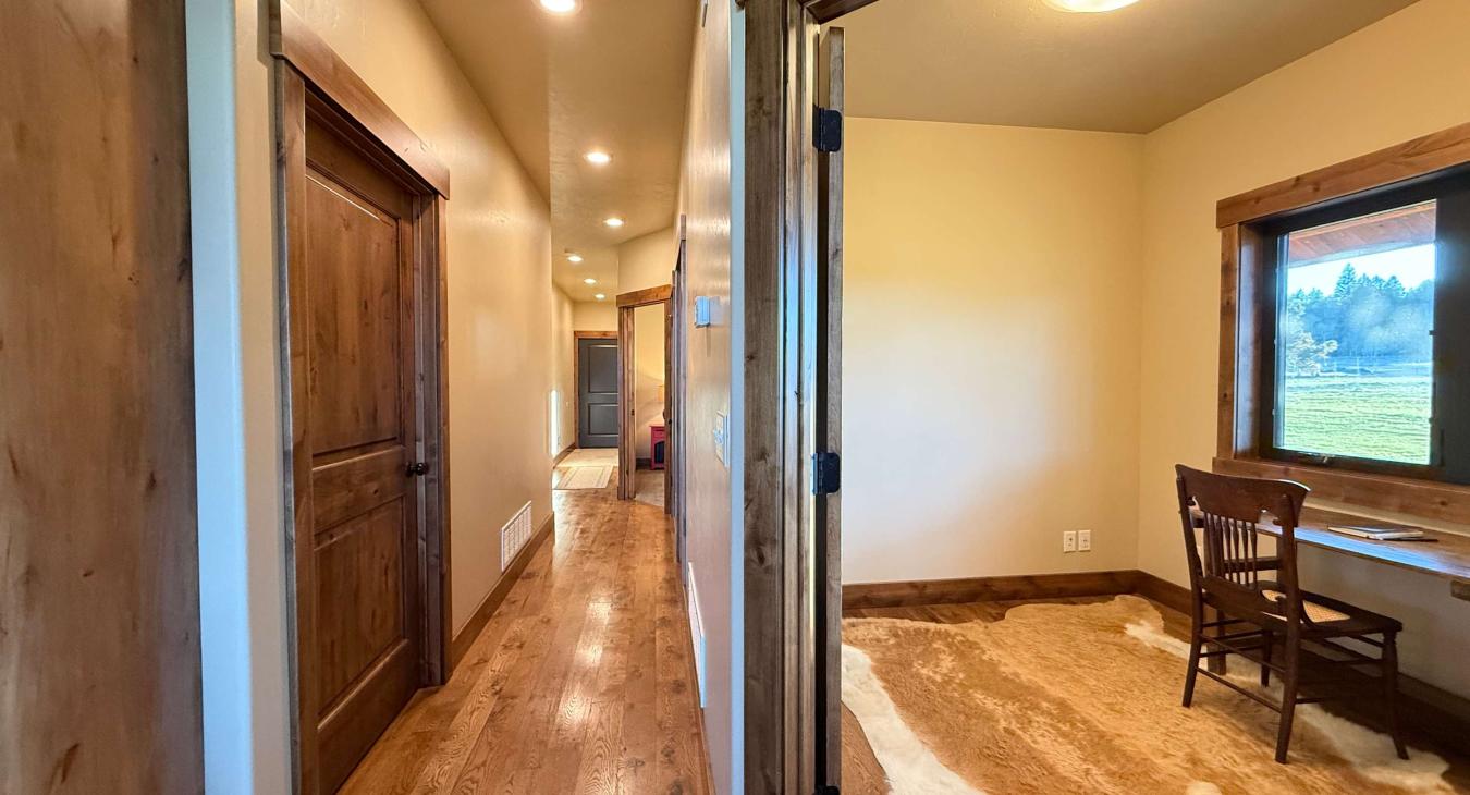 The hallway leads to the office, bathroom, bedrooms and laundry room and out to the garage.
