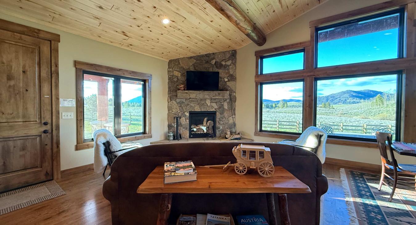 Living room with seating, fireplace, and tv.