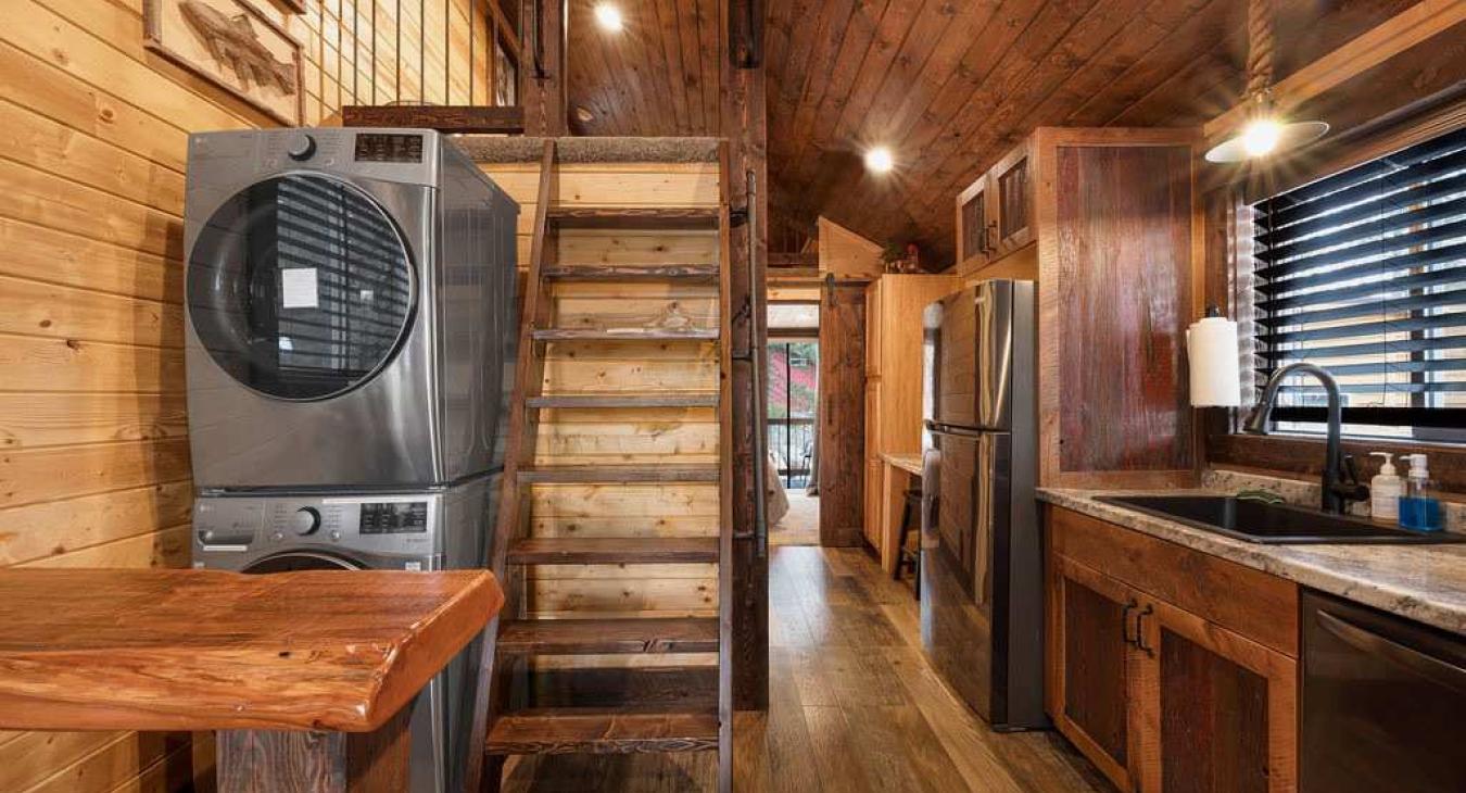 Kitchen with laundry area and ladder for the climb up loft.