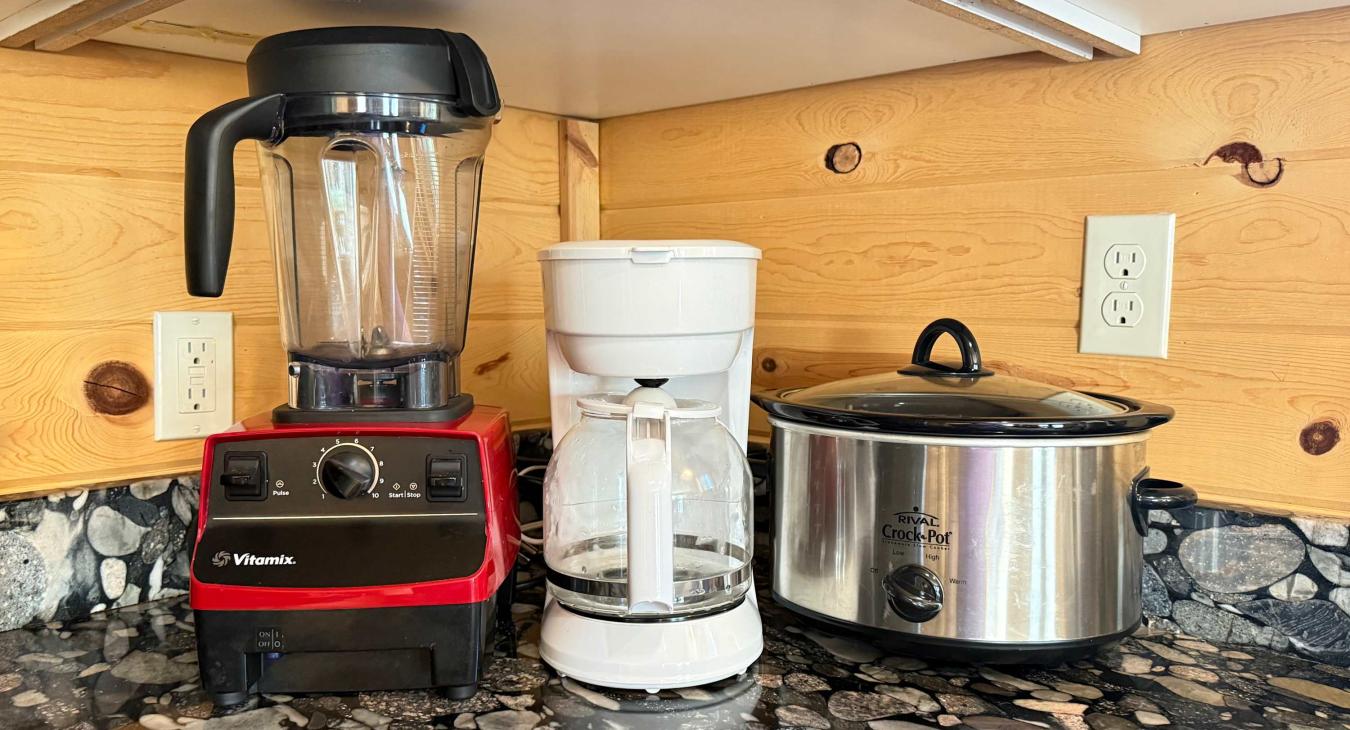 For your cooking convenience, the kitchen comes fully stocked with premium small appliances, including a high-powered Vitamix blender, a drip coffee maker, and a slow cooker.