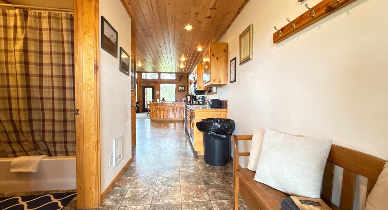 When you walk through the front door you are greeted by the front entry leading into the shared full bathroom and large kitchen.