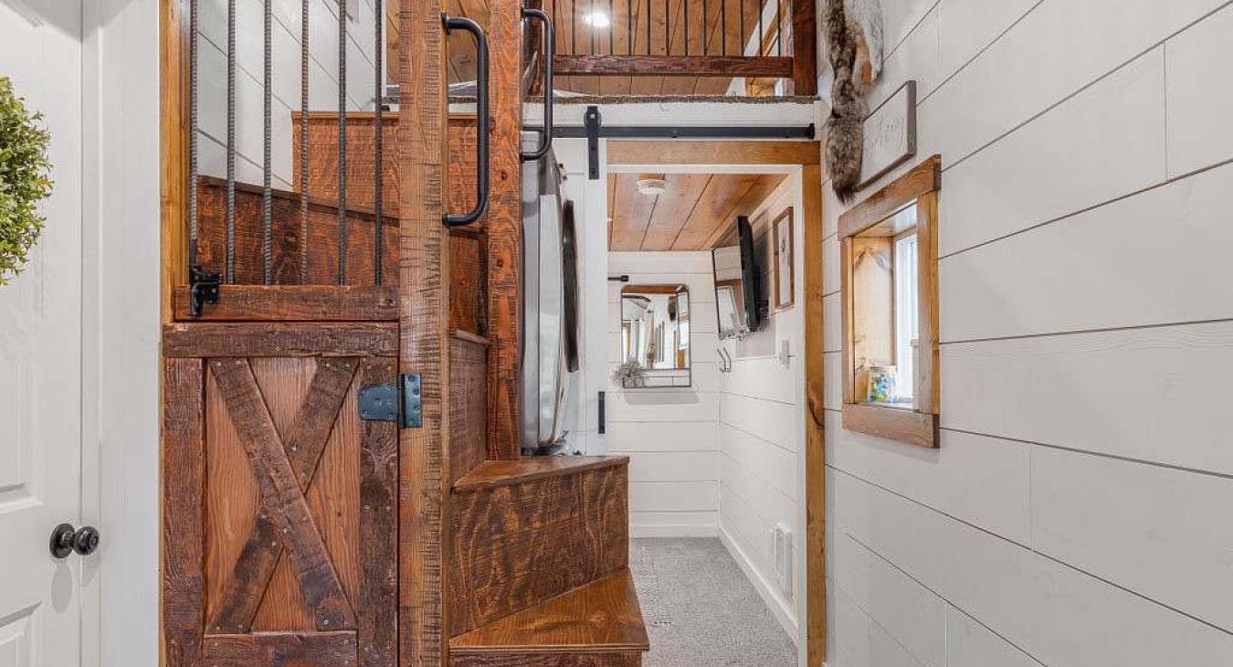 Hallway photo shows the climb in loft and access to the main level bedroom.