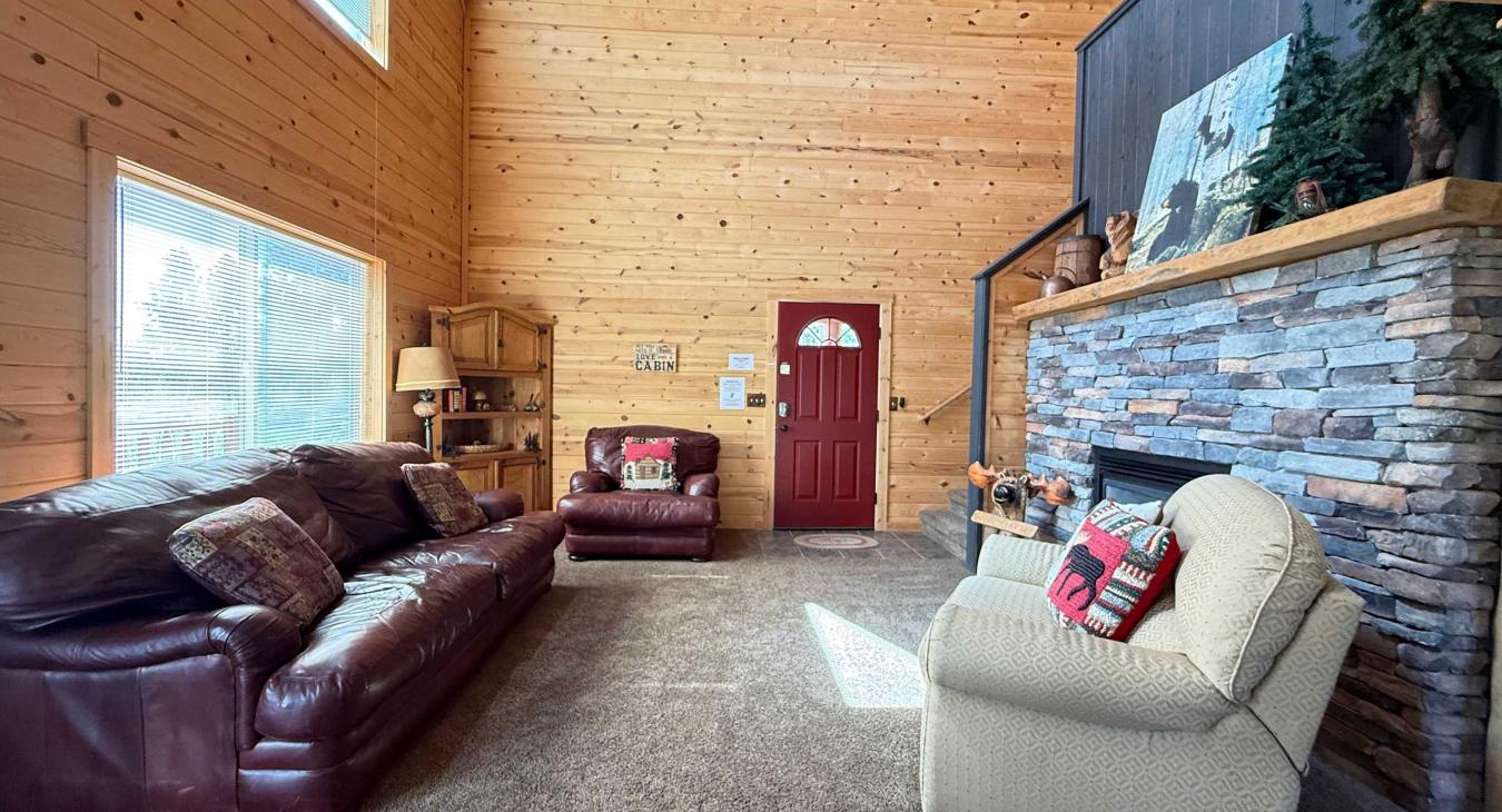 Relax by the striking floor-to-ceiling stone fireplace in the main living space, offering an exceptionally warm and welcoming entry into your mountain getaway.