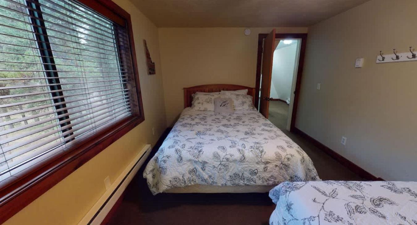 The master bedroom features 2 queen beds.