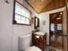 Spacious bathroom with shower/tub, toilet, and sink vantiy.