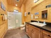Ensuite/ shared bathroom with standing shower, toilet, and sink vanity.