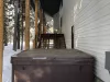 Hot tub is located on the backside of the cabin just down the steps from the wrap around porch.