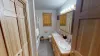 Large bathroom on the main floor features a double sink along with a toilet, and a shower/tub combo.