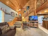 Main level open living room with smart tv that leads to the upstairs.