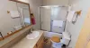 Upstairs shared bathroom with shower/tub, toilet, and sink vanity.