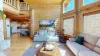 The seating area is inviting, with  large comfortable sectional sofas. This living room is the perfect balance of cozy and spacious, a welcoming spot to gather with family or unwind by the fire while taking in the views of the natural world outside.