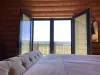 The master bedroom features log walls that create a calm and relaxing environment.