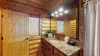 The sink is simple but elegant, with a mirror above. Beneath the vanity, there are drawers and storage space for toiletries, while the countertop holds soap and makeup cloths.