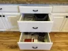 The cabinets may feature pull-out drawers for easy access to smaller appliances like a blender and crockpot.