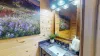Above the vanity hangs a wood-framed mirror. The entire half bathroom feels functional yet charming, with natural materials and a minimalist design that make it feel connected to the cabin's warm, earthy surroundings.