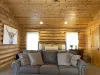 The upstairs bedroom in the cabin is a serene retreat, offering a perfect blend of rustic charm and comfort. The walls are made of natural wood, with the rich grains and warm tones of the timber adding to the cozy, inviting atmosphere.