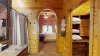 As you step into the entryway of the ensuite bathroom connected to the master bedroom of the cabin, you're greeted by a charming, rustic space that blends functionality with warmth.