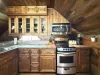 Upstairs is the kitchen with a stove, oven, microwave, fridge. and sink.