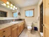 Main level shared bathroom has a deluxe walk-in shower.