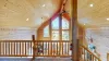Upstairs loft area with natural light from the windows.