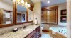Ensuite bathroom with soaking tub, toilet, sink vanity, and walk in shower.