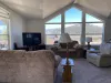Living room area with seating and tv for entertainment.