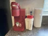 Coffee maker with pods located in the kitchen.