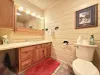 Common bathroom in the hallway. Spacious countertop and full tub and shower.