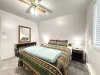 This bedroom features 1 queen bed that will comfortably sleep 2 guests. It also has a window overlooking the beautiful scenery of the cabin.