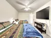 This bedroom features 2 queen beds that can comfortably fit up to 4 guests. It also has a window overlooking the outside of the cabin and a luggage racks for your bags.