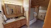 Shared bathroom located upstairs with a double sink vanity, toilet, and shower/tub combo.