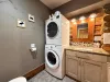 Features a convenient full-size stacked washer and dryer, combining laundry necessity with rustic cabin charm.