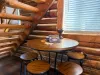 Tucked under the log stairs is a wonderful wooden card table with stools—ideal for playing board games or enjoying a morning puzzle.