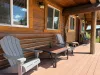 Enjoy your morning coffee on the spacious covered front porch, complete with comfortable Adirondack chairs and a small coffee table.