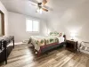 This bedroom features 1 queen bed and bedside tables. There are luggage racks for your suitcases.
