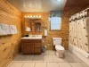 Main level bathroom with shower/tub combo, toilet, and sink vanity.