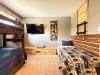 Perfect for kids and families, this spacious room features a sturdy wooden twin-over-twin bunk bed and a separate single bed.